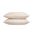 Two beige pillows stacked on a white background
