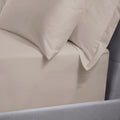 Close-up of latte bedding with a pillow on a bed.