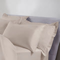 latte pillows on a bed against a plain background
