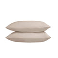 Two beige pillows stacked on a white background