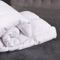 White comforter on a gray bed