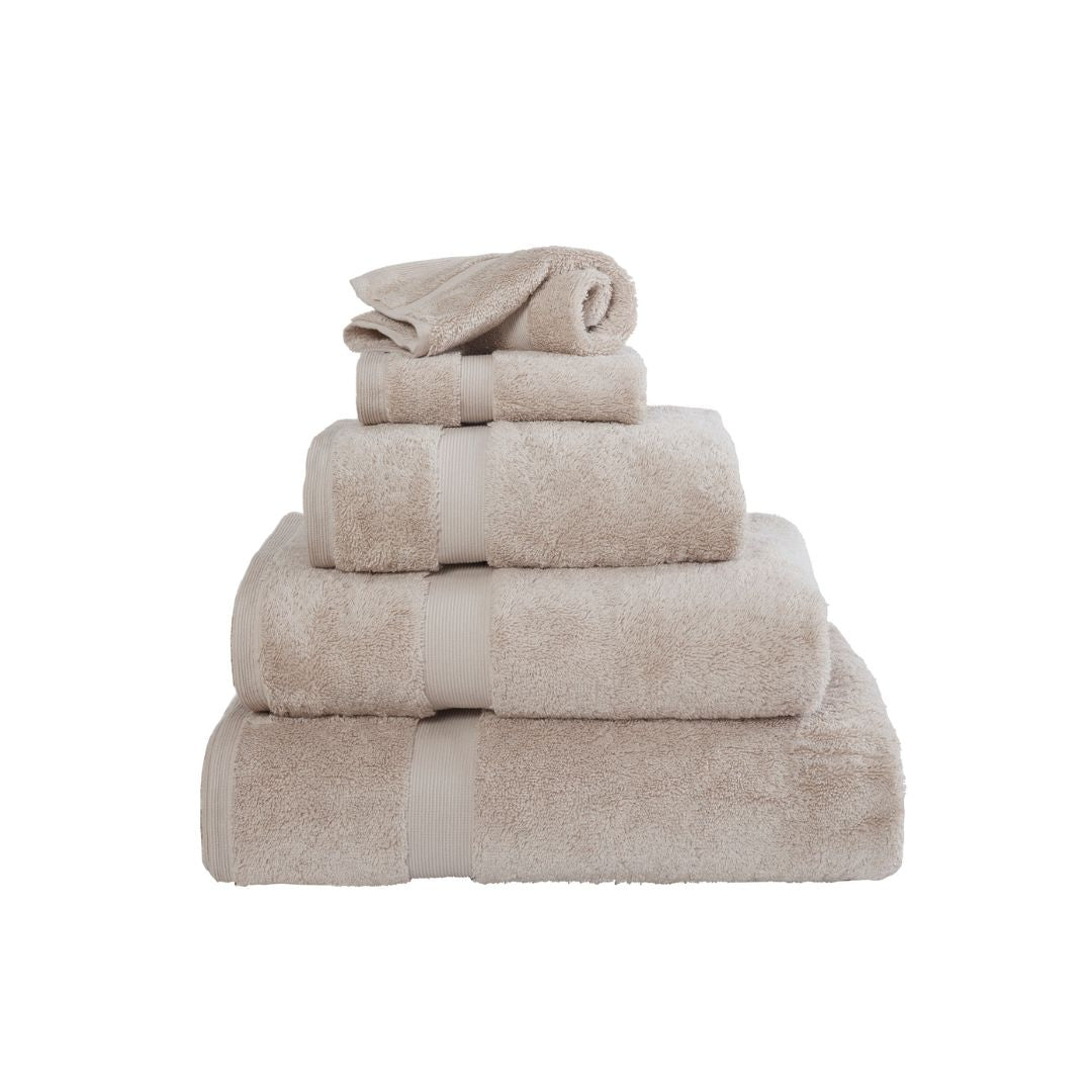 Stack of beige towels on a white background