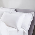 White pillows on a bed with a neutral background