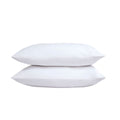 Two white pillows stacked on a white background